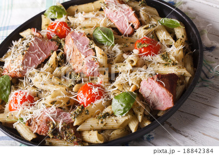Italian pasta penne with meat, parmesan and pesto 18842384