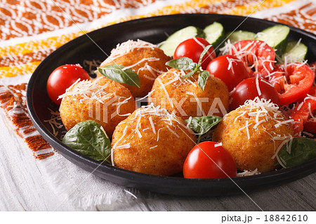 Fried rice balls and fresh vegetable salad 18842610