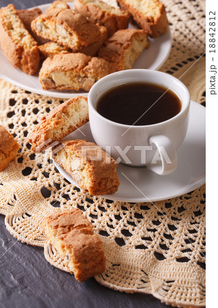 Black coffee and cookies with almonds on a table 18842812