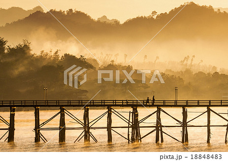 The longest wooden bridge with the morning light. 18848483