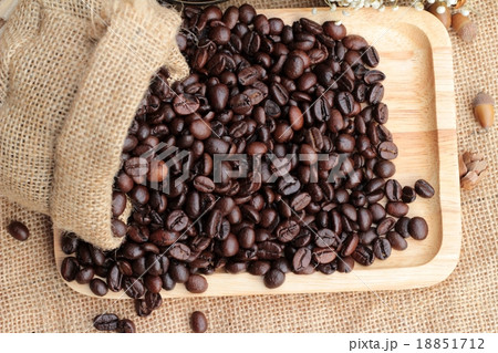 Roasted coffee beans on sack brown background. Roasted coffee beans on sack brown background. 18851712