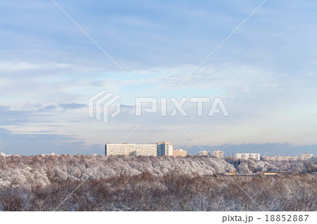 blue clouds in blue sky over snow forest and town 18852887