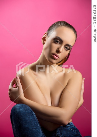 Studio image of beautiful brunette hugging herself 18853328