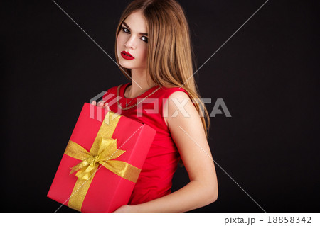 Teen girl is wearing red dress with gift box  18858342