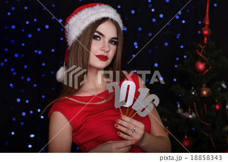 Girl with numbers 2016 near Christmas tree 18858343