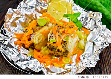 Pike with carrots in foil on board Pike with carrots in foil on board 18858439