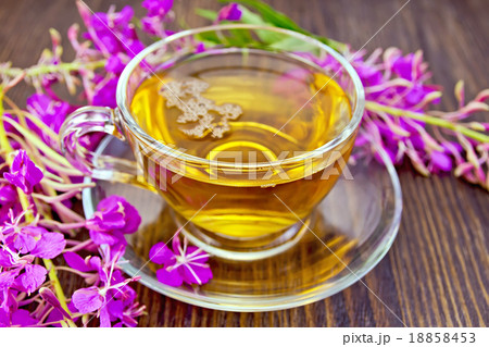 Tea from fireweed in glass cup on board 18858453