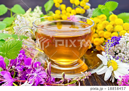 Tea from flowers in glass cup on board Tea from flowers in glass cup on board 18858457