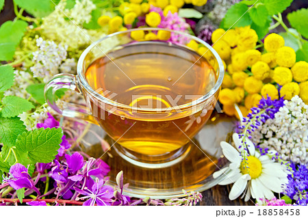 Tea from flowers in glass cup on dark board 18858458
