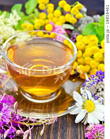 Tea from wild flowers in glass cup on board 18858461