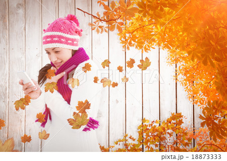 Composite image of attractive woman using her smartphone Composite image of attractive woman using her smartphone 18873333
