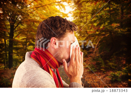 Composite image of man blowing nose on tissue 18873343