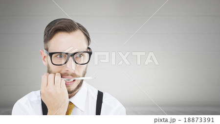 Composite image of geeky hipster biting on pencil 18873391