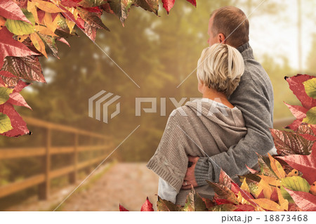 Composite image of happy mature couple in winter clothes Composite image of happy mature couple in winter clothes 18873468