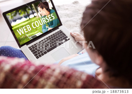 Composite image of pregnant woman using her laptop 18873613
