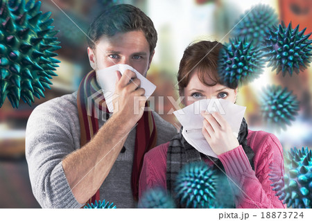 Composite image of couple blowing noses into tissues Composite image of couple blowing noses into tissues 18873724