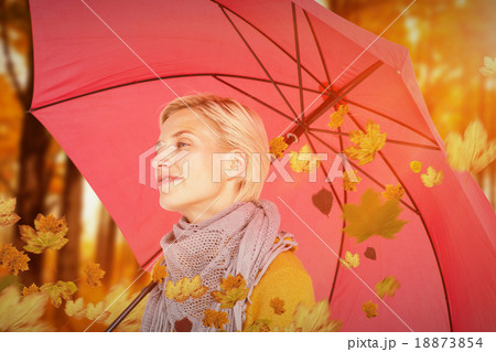 Composite image of happy woman keeping dry 18873854