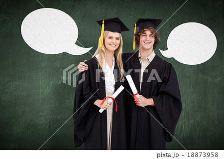 Composite image of two students in graduate robe shoulder to sho 18873958