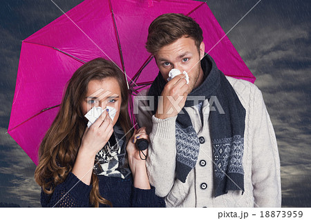 Composite image of couple blowing nose while holding umbrella 18873959