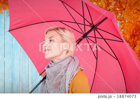 Composite image of happy woman keeping dry Composite image of happy woman keeping dry 18874073