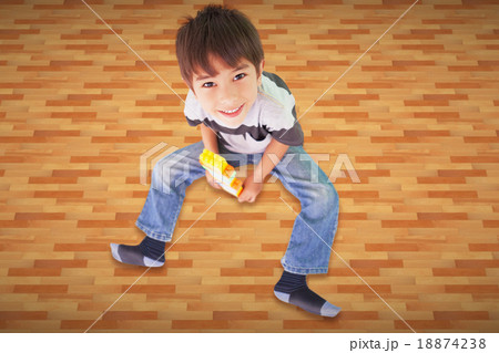 Composite image of cute boy sitting with building blocks Composite image of cute boy sitting with building blocks 18874238
