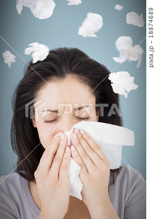 Composite image of sick brunette blowing her nose 18874689