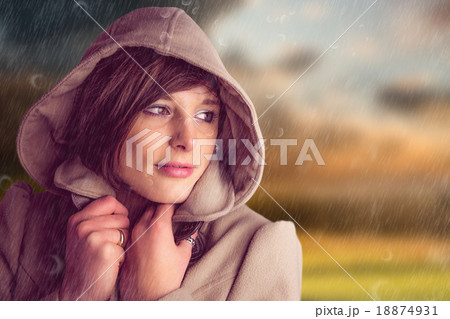 Composite image of beautiful woman wearing winter coat looking a 18874931