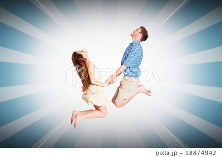 Composite image of cheerful young couple jumping 18874942