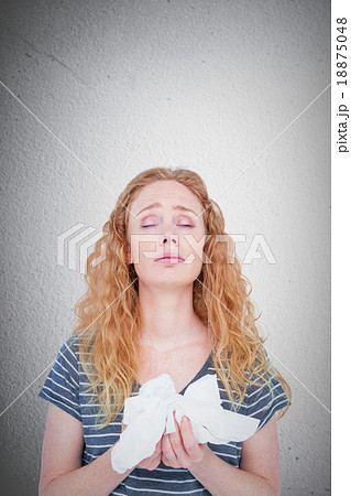 Composite image of sick blonde woman holding paper tissue Composite image of sick blonde woman holding paper tissue 18875048
