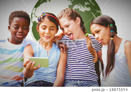 Composite image of happy children taking selfie at park Composite image of happy children taking selfie at park 18875054