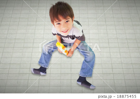 Composite image of cute boy sitting with building blocks Composite image of cute boy sitting with building blocks 18875455
