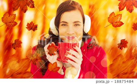 Composite image of woman in winter clothes enjoying a hot drink Composite image of woman in winter clothes enjoying a hot drink 18875484