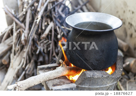 black pot boiling water for cooking on fired stove 18876627
