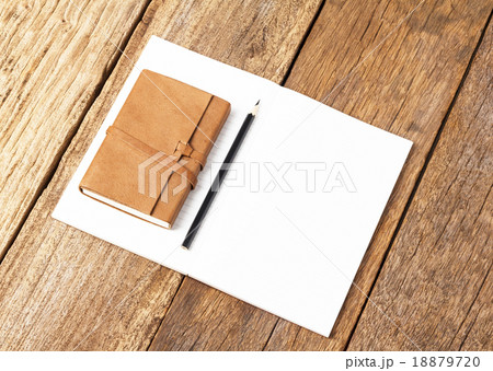 Blank open notebook with black pencil on wood Blank open notebook with black pencil on wood 18879720