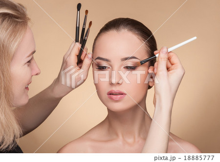 Professional beautician is working with the model 18885777