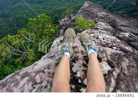 woman hiker legs relax at mountain peak cliff woman hiker legs relax at mountain peak cliff 18886681