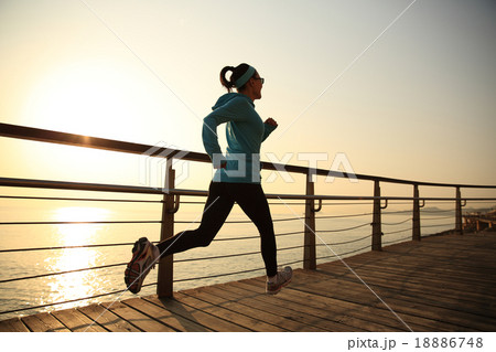 woman running on sunrise seaside boardwalk woman running on sunrise seaside boardwalk 18886748