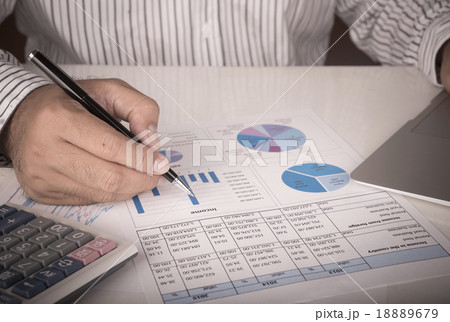 businessman analyzing data report businessman analyzing data report 18889679