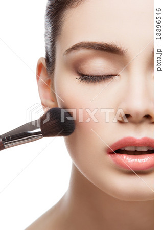 Beautiful girl applying blush with brush 18896546
