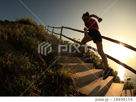 fitness woman runner trail running on seaside   18898154