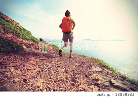 young woman backpacker walking on seaside  18898832