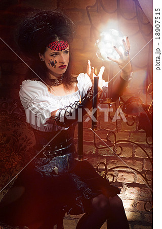 Young witch with candles Young witch with candles 18907515