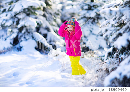 Child having fun in snowy winter park 18909449