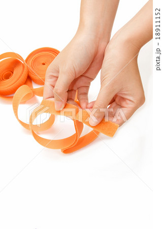 hand holding roll of velco on white background hand holding roll of velco on white background 18911152