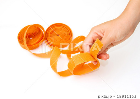 hand holding  roll of velco on white background  18911153