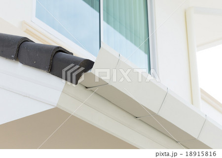 white gutter on the roof top of house 18915816