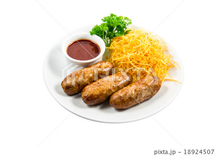 Grilled sausage with garnish and sauce on plate 18924507