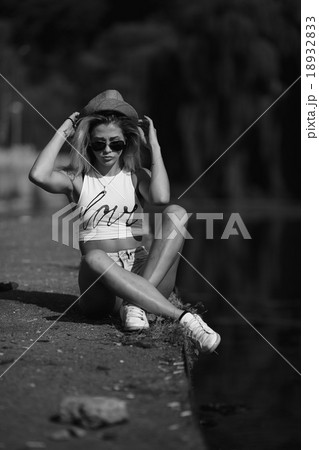 beautiful girl sitting on the pier 18932833