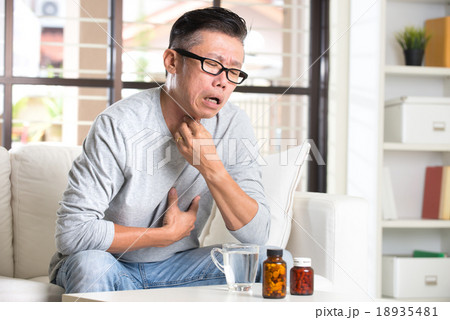 asian senior with throat pain and medicine asian senior with throat pain and medicine 18935481