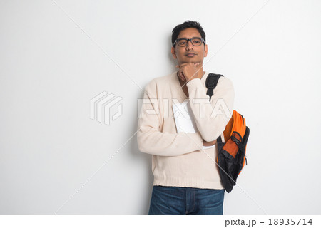 Happy young man using digital tablet Happy young man using digital tablet 18935714